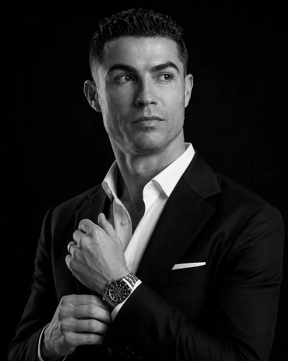 High-end 8K cinematic black-and-white portrait of a man adjusting a luxury chronograph watch