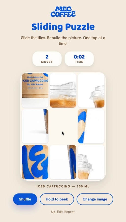 MEC Coffee sliding puzzle demo — a 3x3 tile puzzle showing an iced cappuccino image being rebuilt tile by tile, with Shuffle / Hold to peek / Change image controls